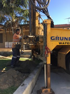 Drilling garden bore over low wall