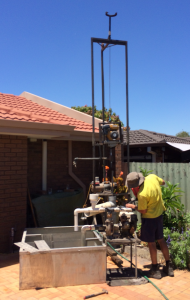 Small portable rig for water boring in tight confines.
